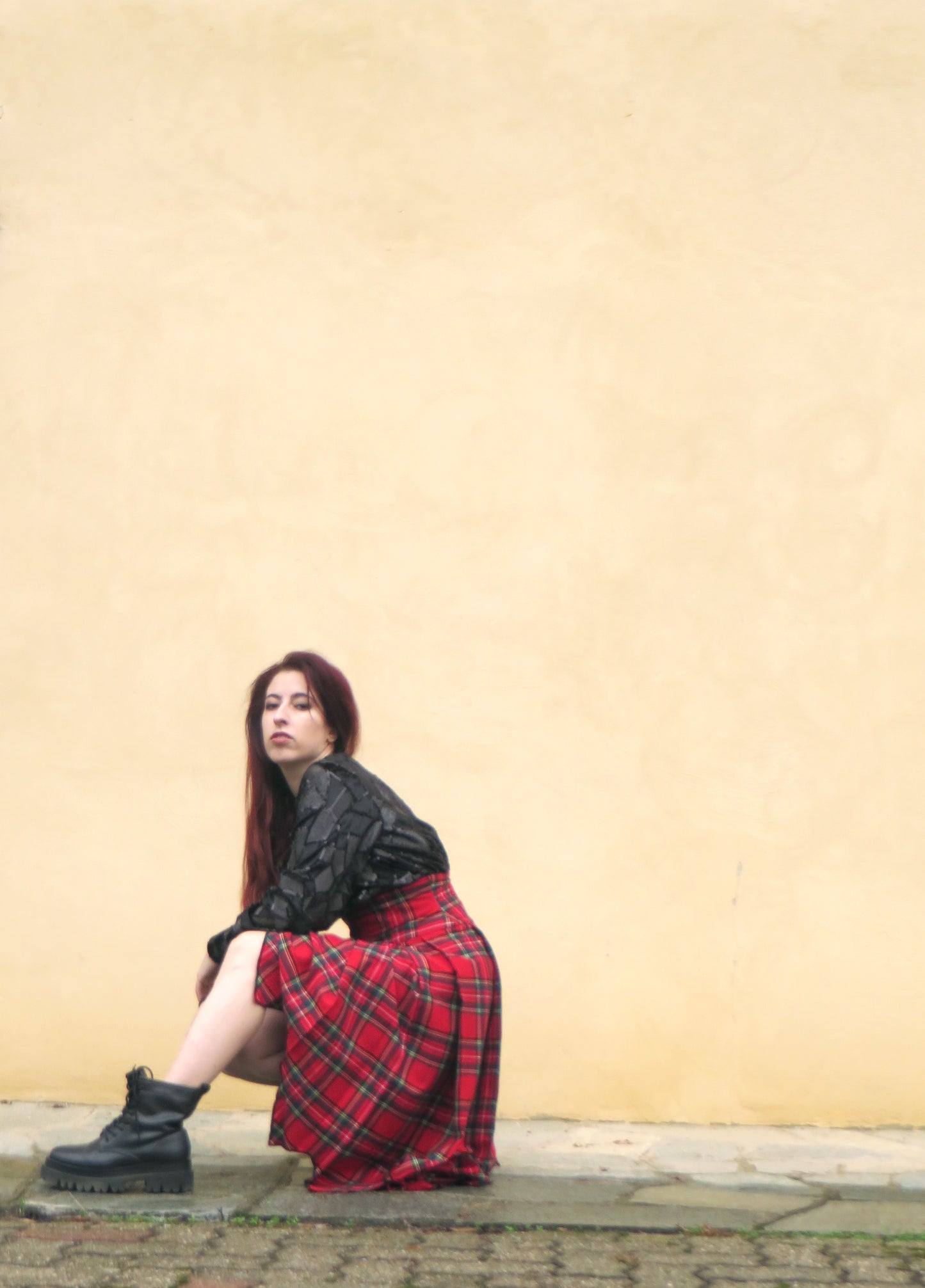 asymmetrical red skirt and a luxurious black velvet blouse